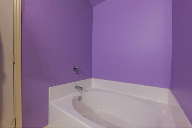 bathroom featuring a relaxing tiled tub