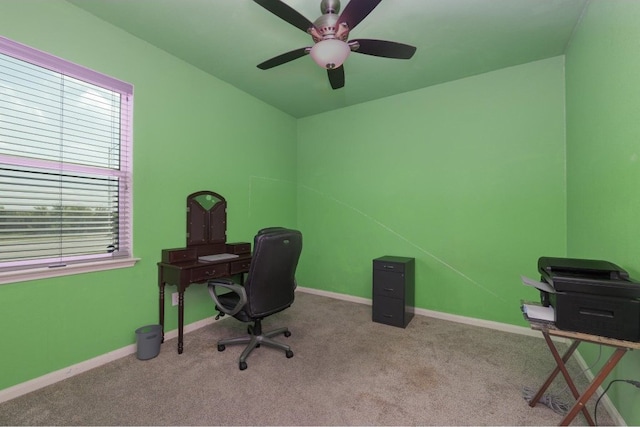 carpeted office space with ceiling fan