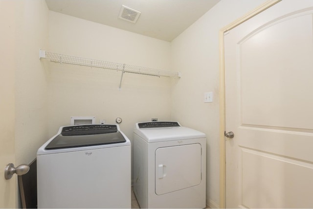 clothes washing area featuring washing machine and clothes dryer