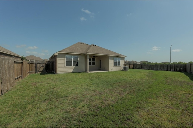 rear view of property featuring central AC, a lawn, and a patio area