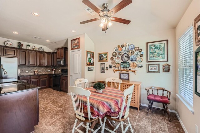 dining area featuring vaulted ceiling, ceiling fan, and sink