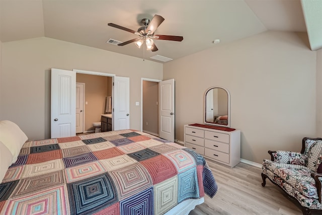 bedroom with ceiling fan, light hardwood / wood-style flooring, ensuite bath, and vaulted ceiling