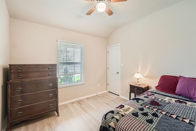 bedroom with ceiling fan, lofted ceiling, and light hardwood / wood-style floors