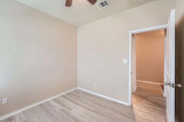 empty room featuring ceiling fan and light hardwood / wood-style floors