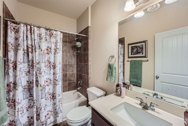 full bathroom featuring toilet, shower / bath combo, and vanity