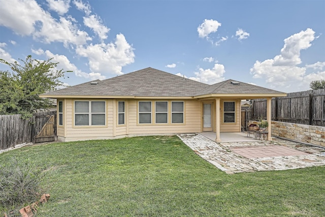 rear view of house featuring a patio area and a lawn