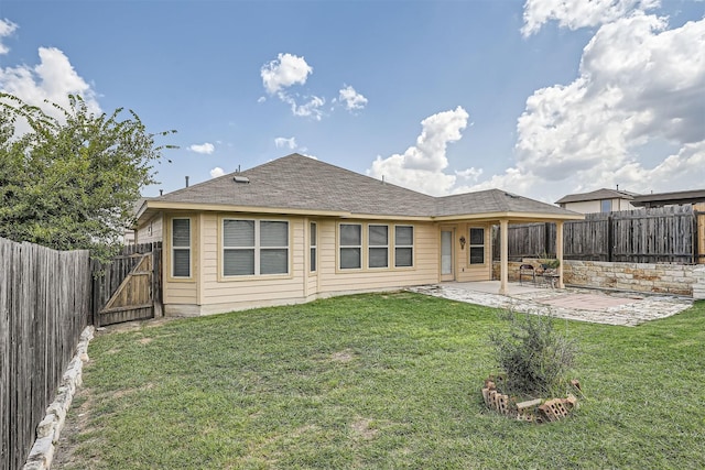 rear view of property featuring a patio area and a lawn