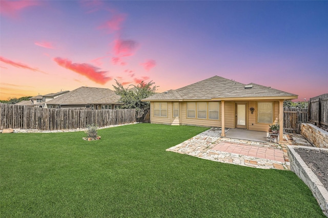 yard at dusk with a patio area