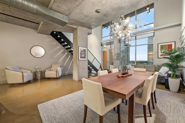 dining room with a high ceiling and an inviting chandelier