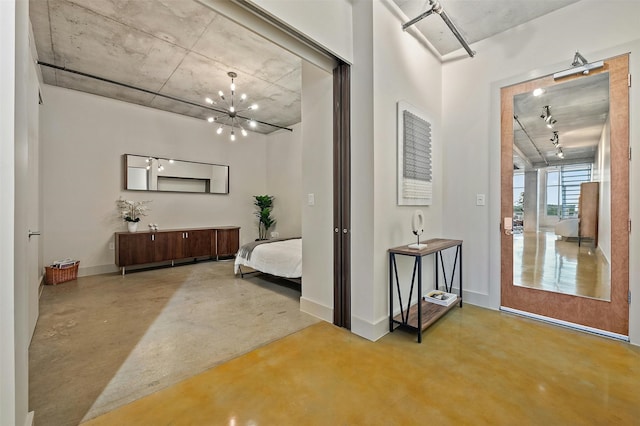 interior space with a notable chandelier and concrete flooring