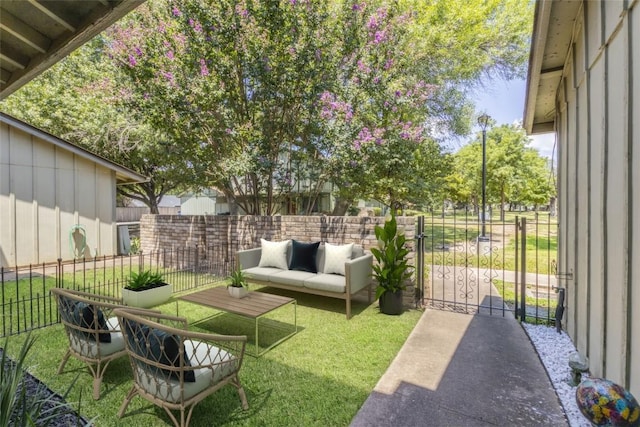 view of yard featuring an outdoor living space, a gate, and fence