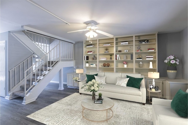 living room with stairs, wood finished floors, and ceiling fan