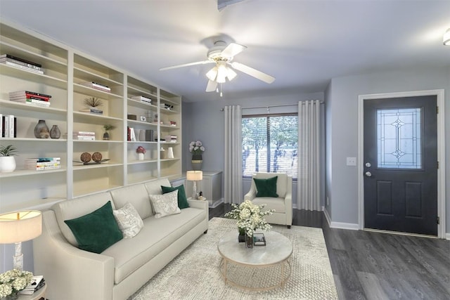 living room featuring dark wood-type flooring and ceiling fan