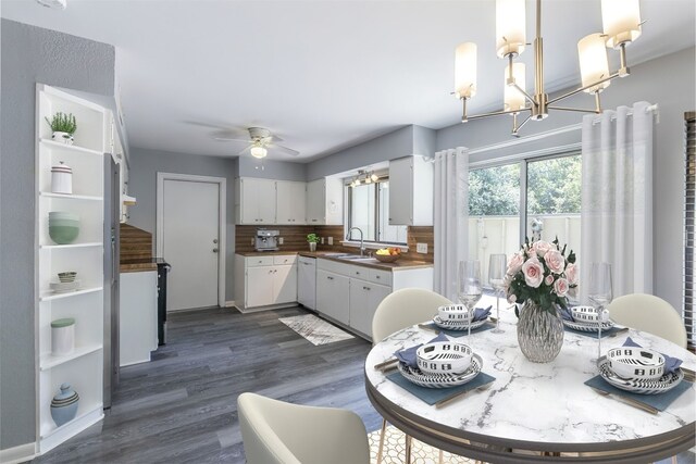 dining space with ceiling fan and dark wood finished floors