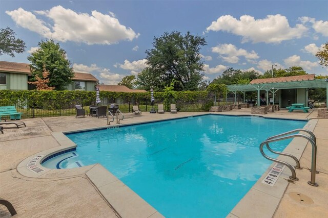 pool with a pergola, a patio, and fence