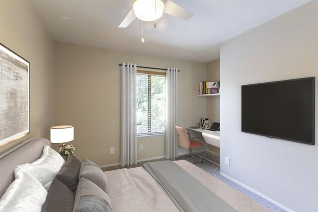 carpeted bedroom featuring baseboards and ceiling fan