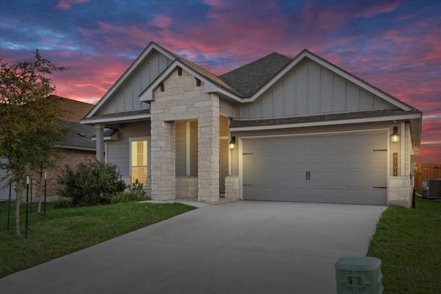 craftsman inspired home with a garage and a yard