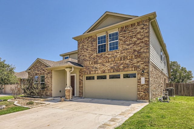 view of front property featuring a front lawn and a garage