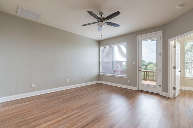 unfurnished room featuring plenty of natural light, ceiling fan, and light hardwood / wood-style floors