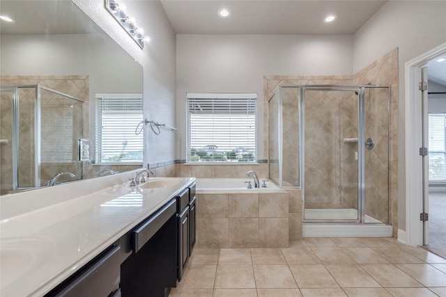 bathroom featuring shower with separate bathtub, tile patterned floors, and dual vanity