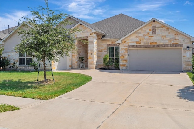 view of front of house featuring a front lawn and a garage