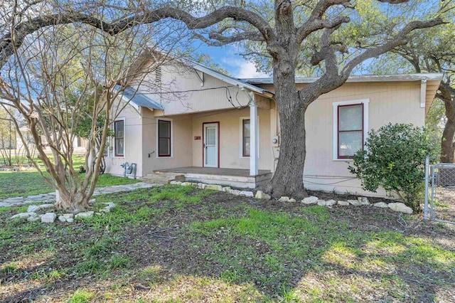 view of front of home with a porch and a front yard