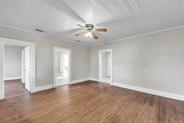 empty room with hardwood / wood-style floors, ceiling fan, and ornamental molding