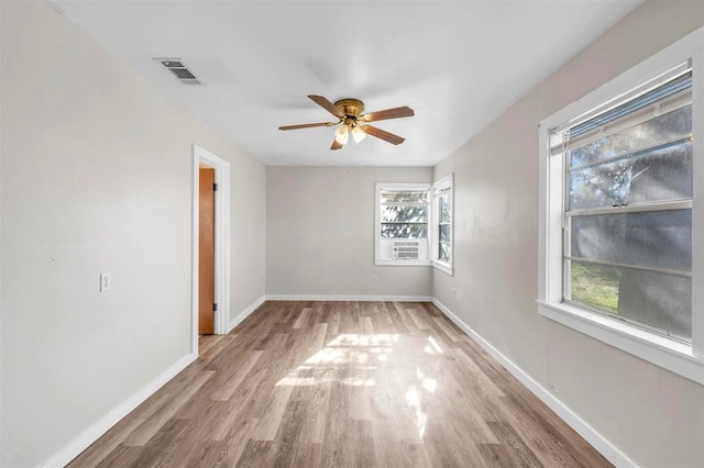 unfurnished room featuring ceiling fan, a healthy amount of sunlight, and light wood-type flooring