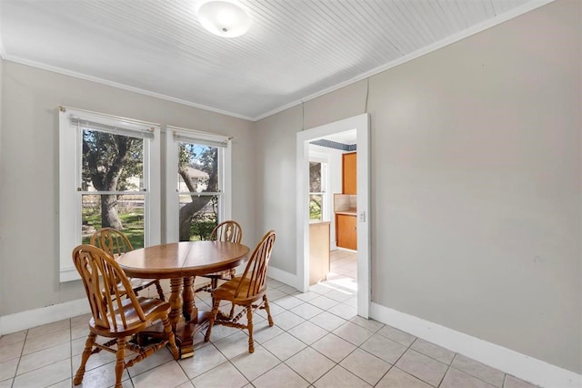 tiled dining room featuring crown molding