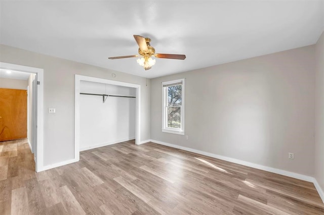 unfurnished bedroom featuring a closet, light hardwood / wood-style floors, and ceiling fan