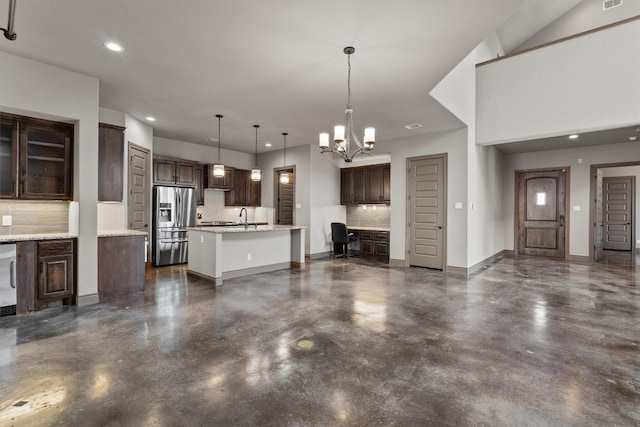 unfurnished living room with sink and a chandelier