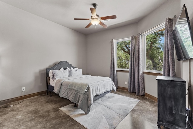 bedroom with ceiling fan and concrete floors