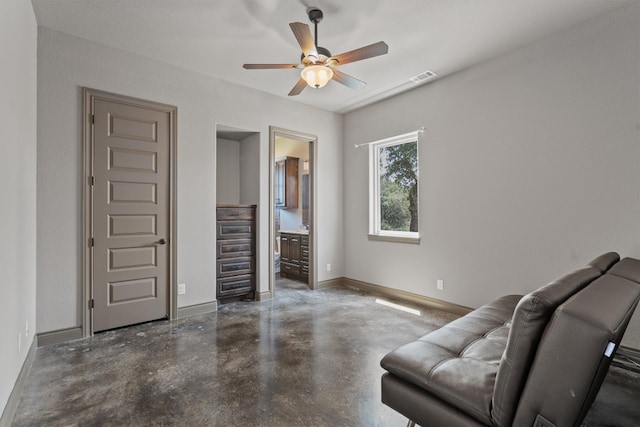 living room featuring ceiling fan and concrete floors