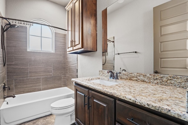 full bathroom featuring tiled shower / bath combo, vanity, and toilet