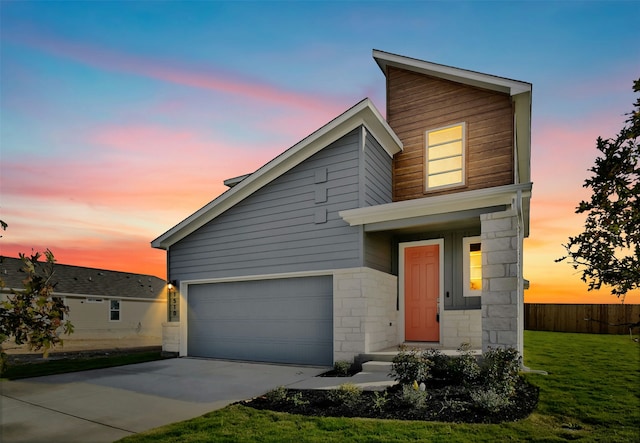 view of front facade featuring a garage and a yard