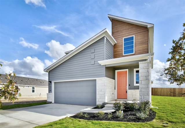 view of front of home with a front lawn and a garage