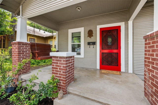 view of exterior entry featuring a porch