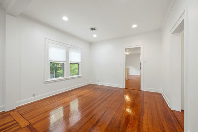 unfurnished bedroom featuring crown molding and hardwood / wood-style flooring