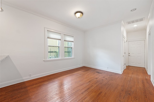 unfurnished room with crown molding and wood-type flooring