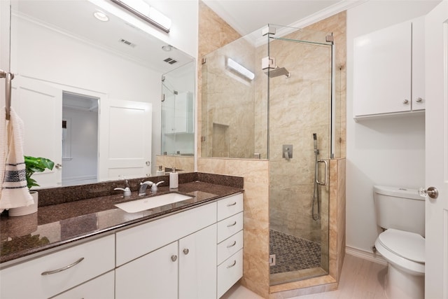 bathroom with crown molding, walk in shower, vanity, and toilet