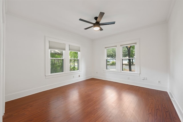 unfurnished room featuring ceiling fan, dark hardwood / wood-style floors, and crown molding