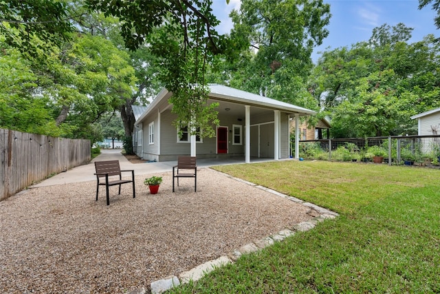 back of property featuring a lawn and a patio