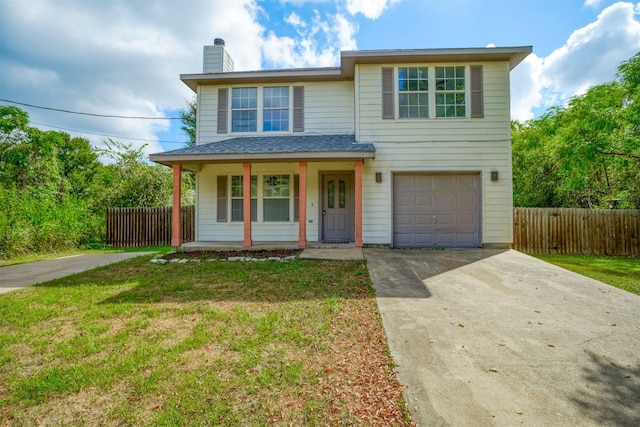 front of property featuring covered porch, a garage, and a front yard