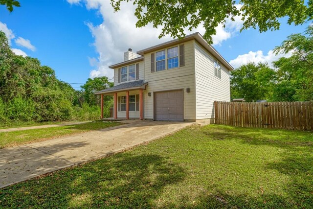 view of property featuring a front lawn and a garage