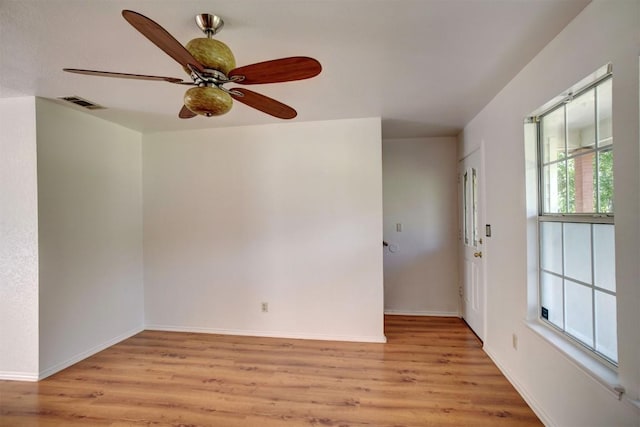 empty room with light wood-type flooring, baseboards, visible vents, and ceiling fan