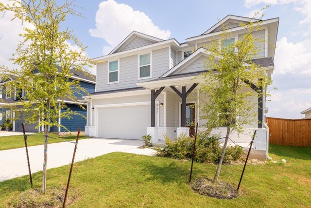 craftsman house with a garage and a front lawn