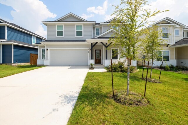 view of front of house with a garage and a front yard