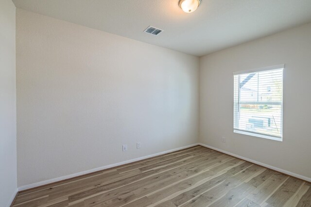 unfurnished room featuring hardwood / wood-style flooring