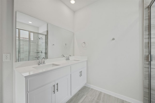 bathroom featuring an enclosed shower and vanity