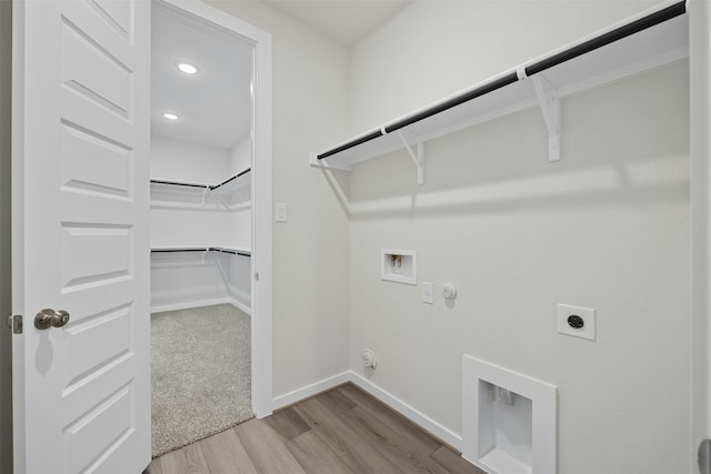 clothes washing area featuring hookup for a gas dryer, wood-type flooring, hookup for a washing machine, and hookup for an electric dryer